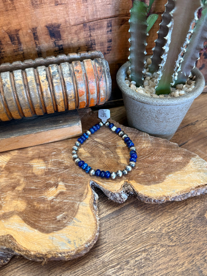 Deep blue and silver beaded stretchy bracelet with silver spacer beads and size tag