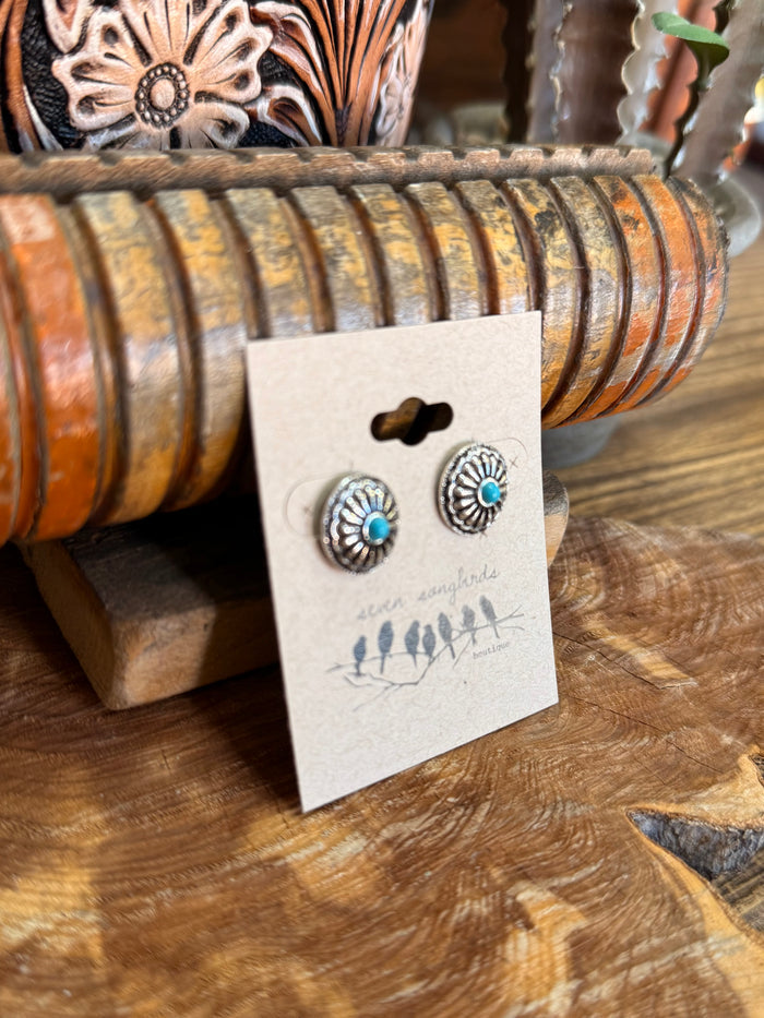 Silver-tone round concho stud earrings with turquoise center, shown at angle