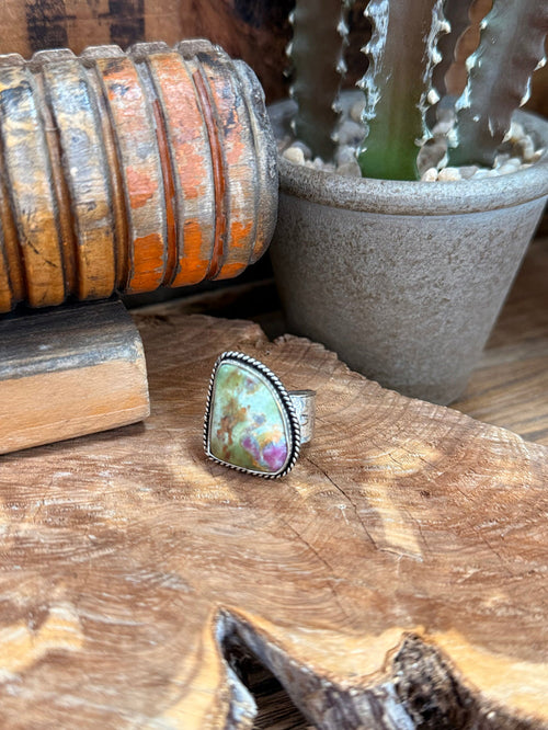 Adjustable silver-tone ring with oval iridescent natural stone cabochon, detailed bezel edge