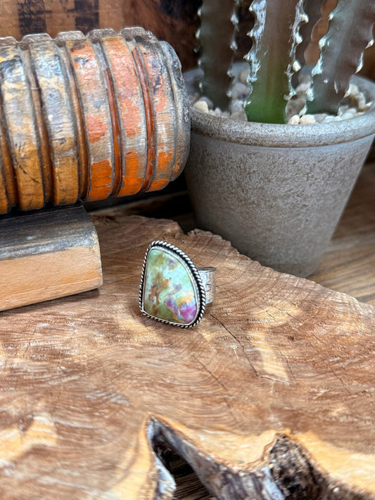 Adjustable silver-tone ring with oval iridescent natural stone cabochon, detailed bezel edge