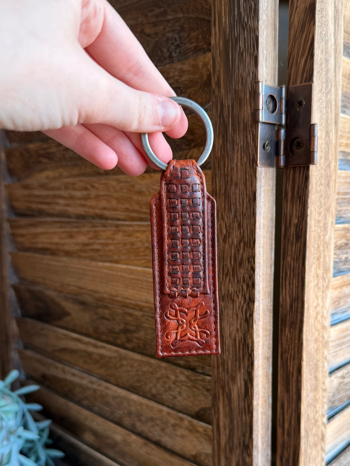Rusty brown braided-style leather keychain with metal key ring, front tag with embossed details