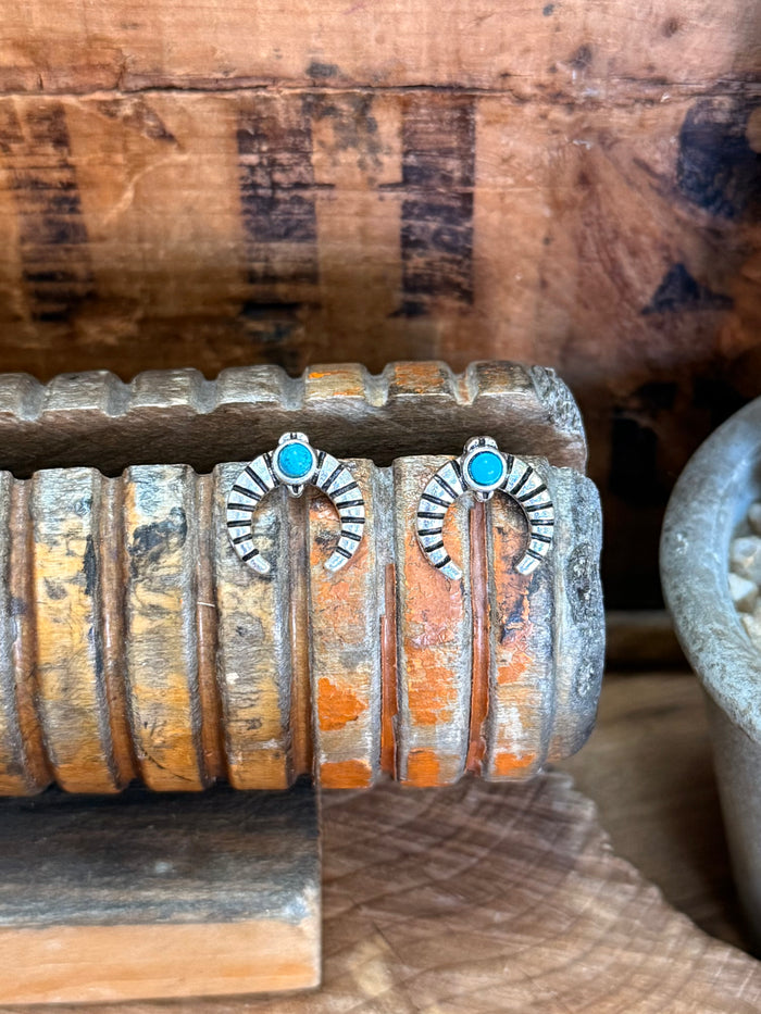 Silver naja stud earrings with turquoise round stones and etched sunburst detailing