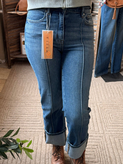 Front-seam medium-wash jeans with cuffed hems and front fly pocket details.