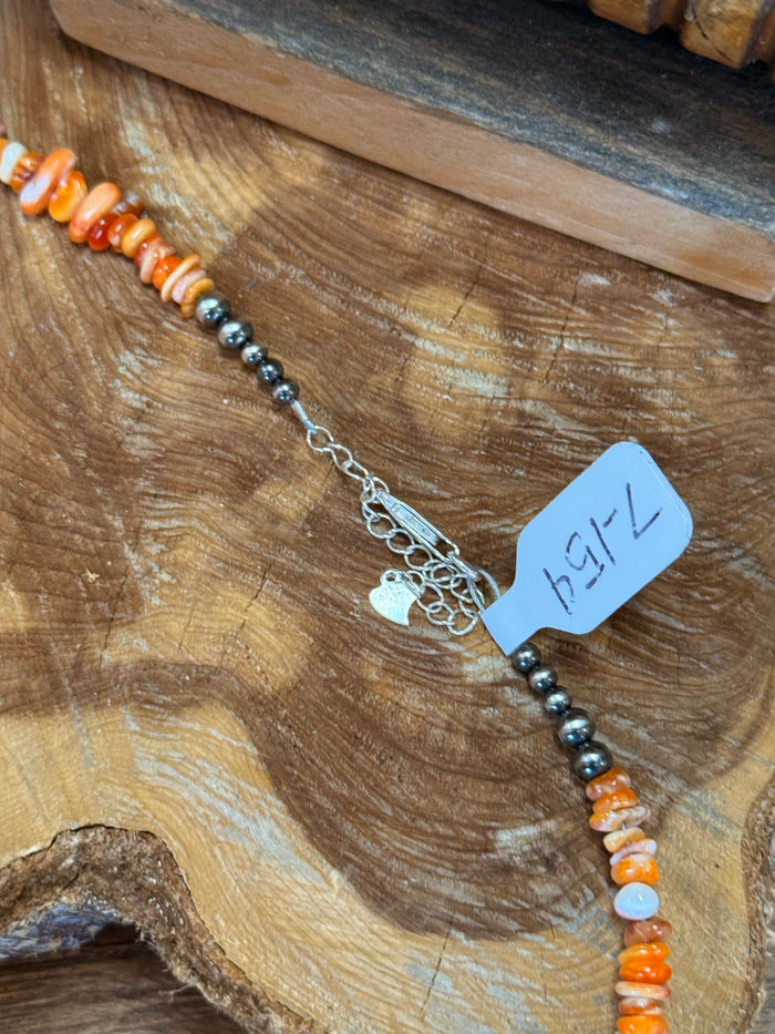 Spiny oyster chip necklace with lobster clasp and small tag, silver-tone beads