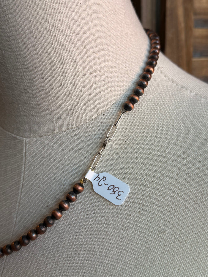 Copper bead necklace with metal tag charm on strand