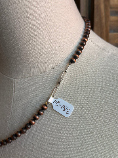 Copper bead necklace with metal tag charm on strand