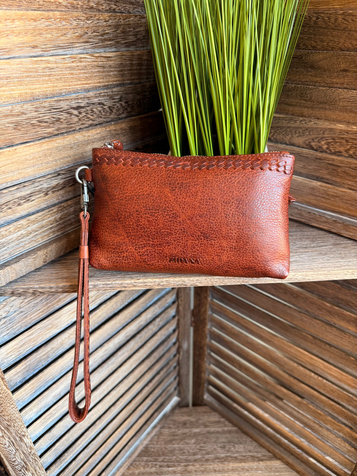 Rusty brown mini wristlet bag with metal wrist strap and zip top closure
