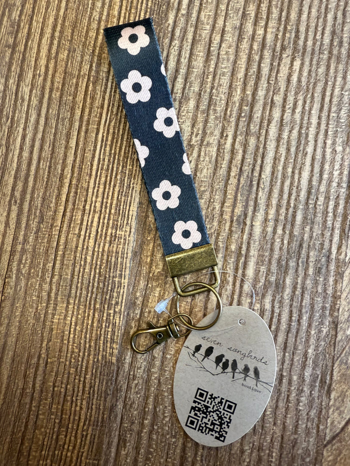Navy daisy wristlet key chain with gold keyring and round QR tag