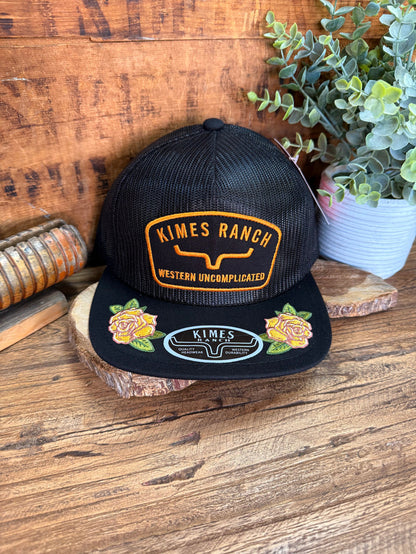 Black mesh baseball cap with embroidered Kimes Ranch patch and rose graphics