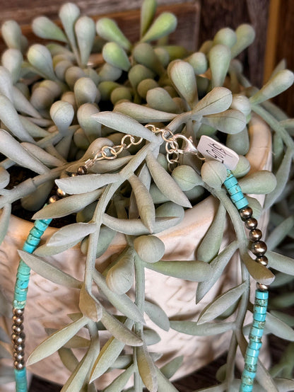 Blue turquoise heishi bead necklace with gold-tone beads and metal clasp