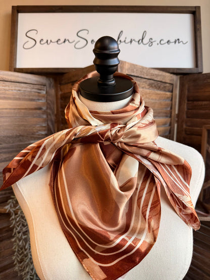 Wild rag scarf draped on mannequin, horse print in warm tan and rust
