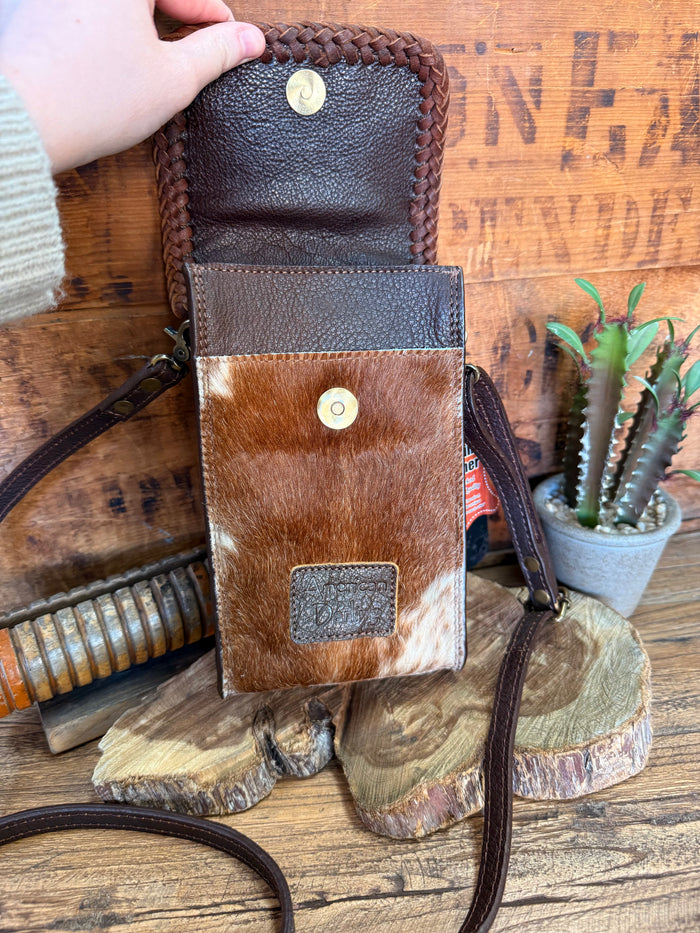 Two-tone cowhide crossbody pouch bag with flap front, braided sides, and small top snap