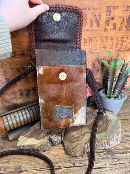 Two-tone cowhide crossbody pouch bag with flap front, braided sides, and small top snap