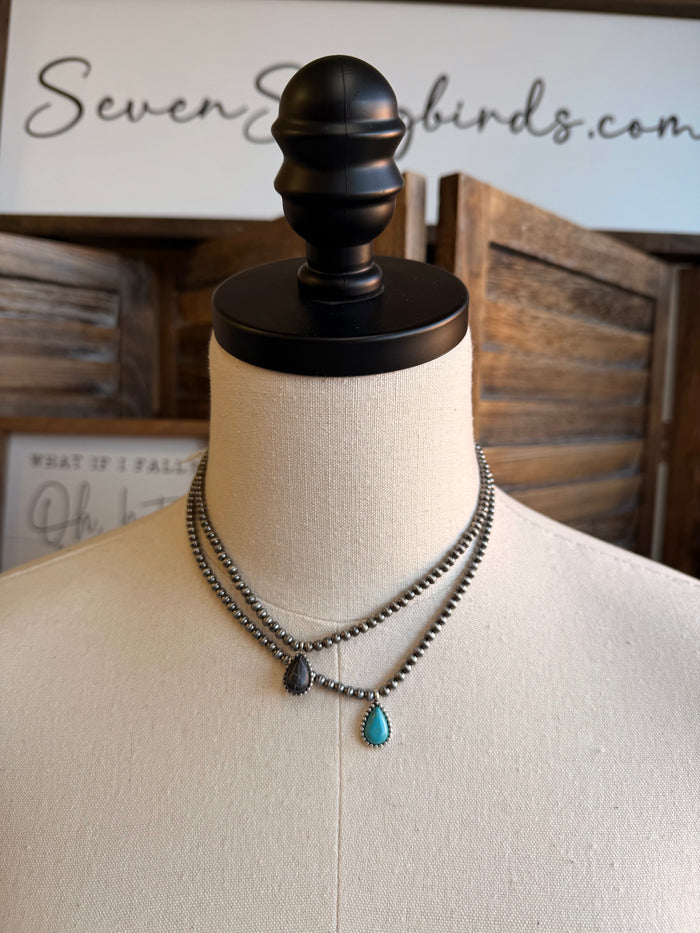 Silver-tone bead choker with turquoise teardrop center pendant and small dark beads