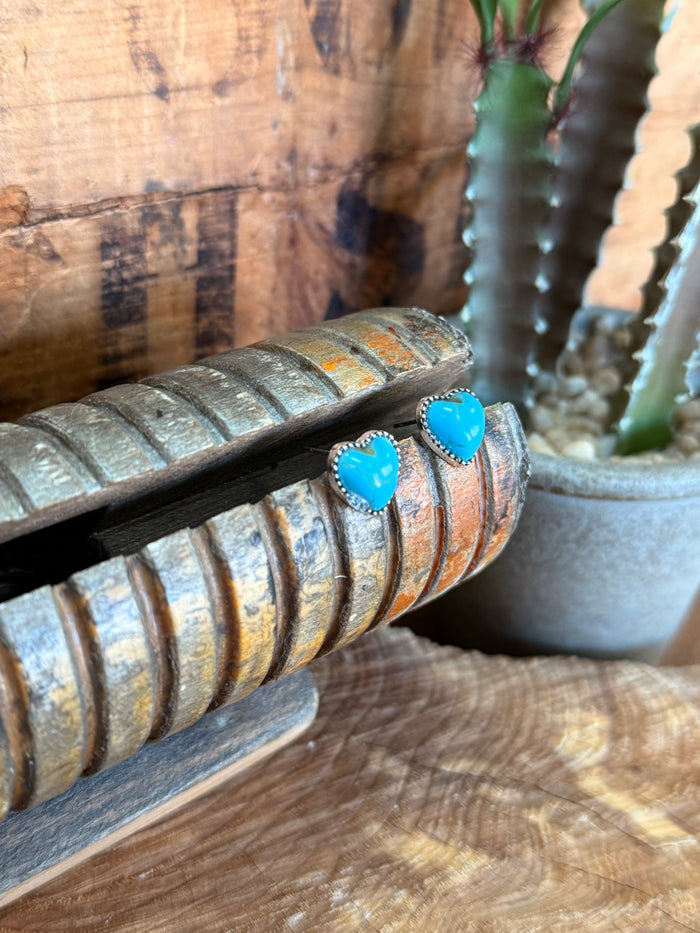 Turquoise heart stud earring with silver-tone bezel, side view