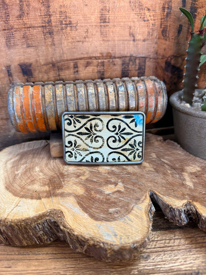Silver belt buckle with ornate scroll engraving and rectangular frame