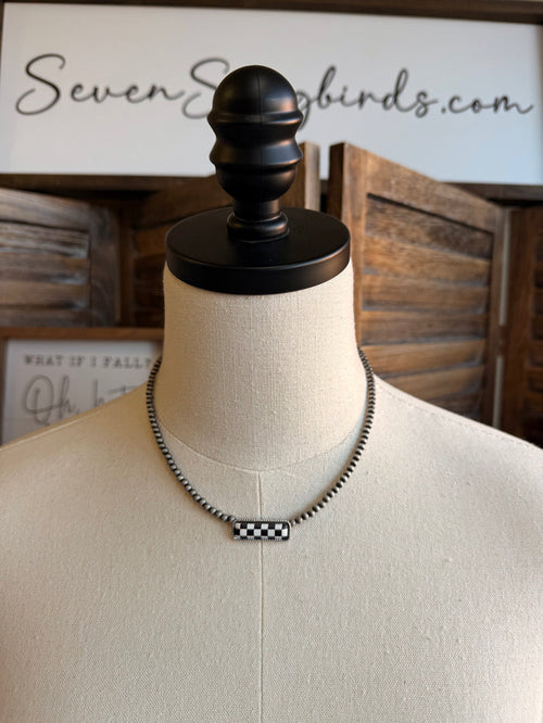Checker bar pendant necklace with silver-tone chain and black-and-white checkered bar