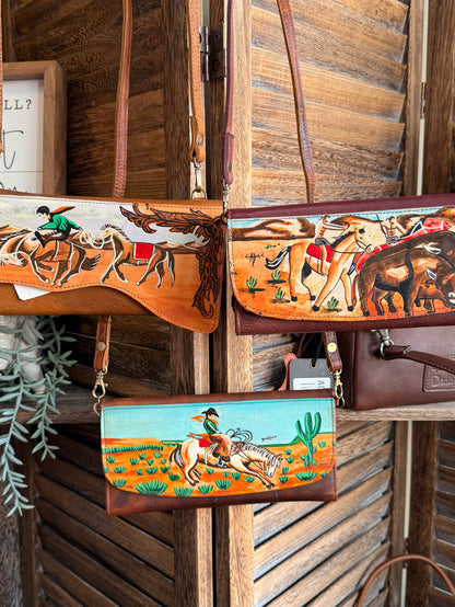 Hand-painted leather crossbody wallet with orange western horse illustration and strap