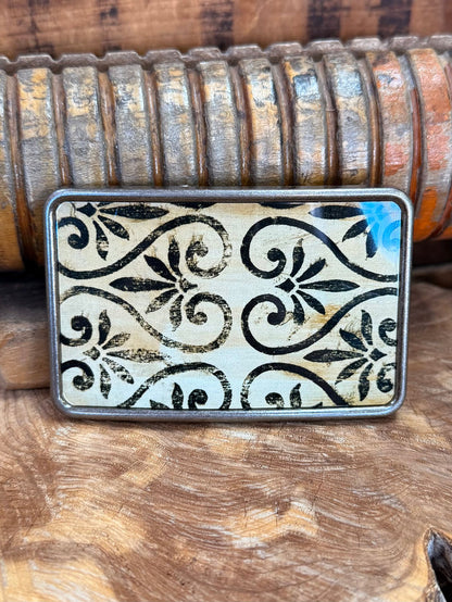 Rectangular silver belt buckle with bold floral scroll pattern engraving