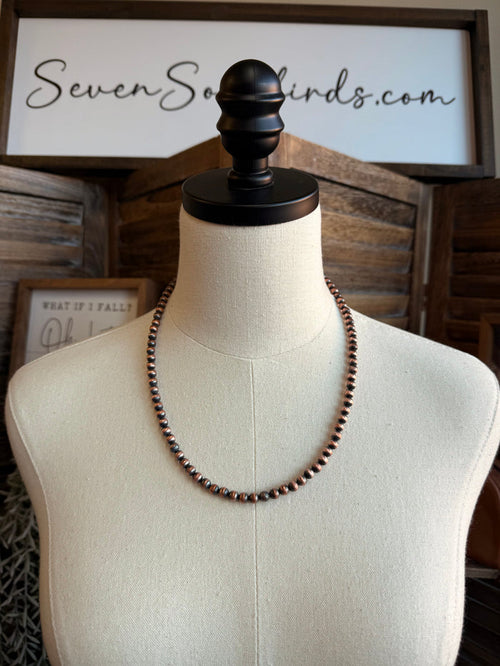 Copper bead necklace on mannequin, rounded copper bead strand