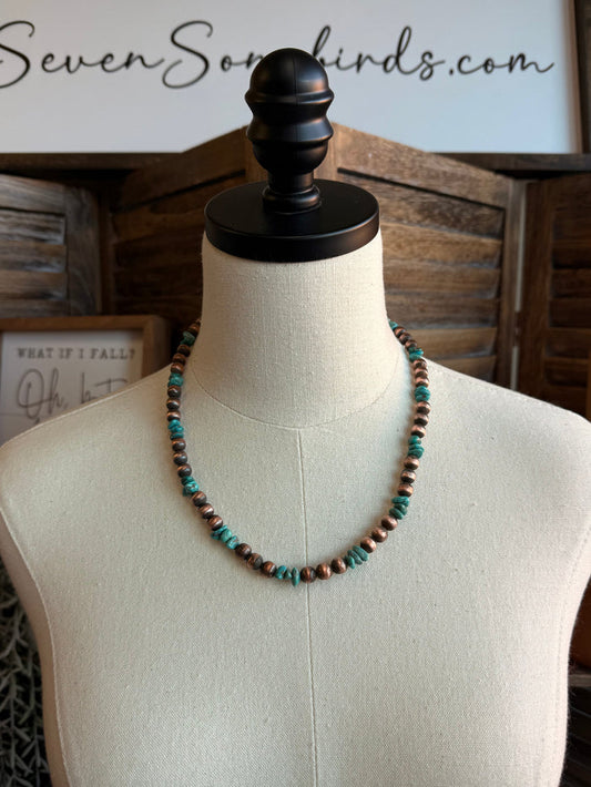 Beaded turquoise and copper bead necklace with round beads on a mannequin bust