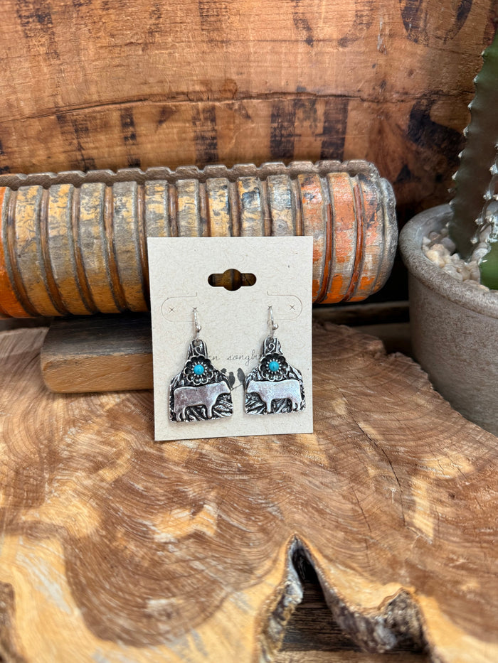 Silver cow tag fishhook earrings with turquoise bead drops and engraved cow scene