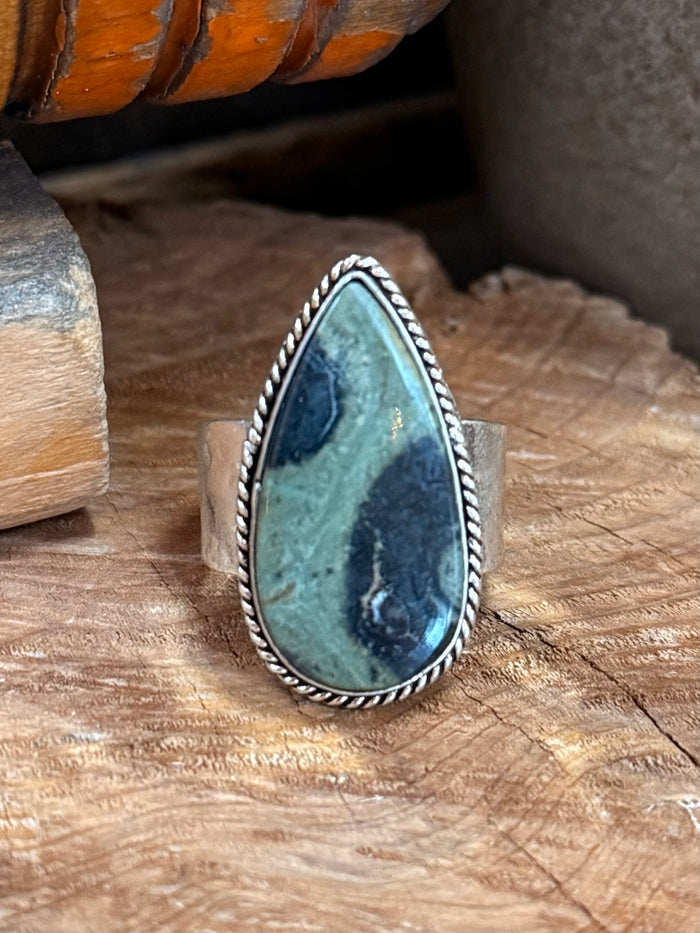 Teardrop adjustable ring featuring blue-green natural stone in silver-toned frame