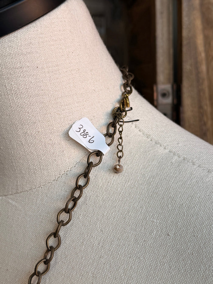Pearl bead pendant necklace clasp and chain detail with small number tag