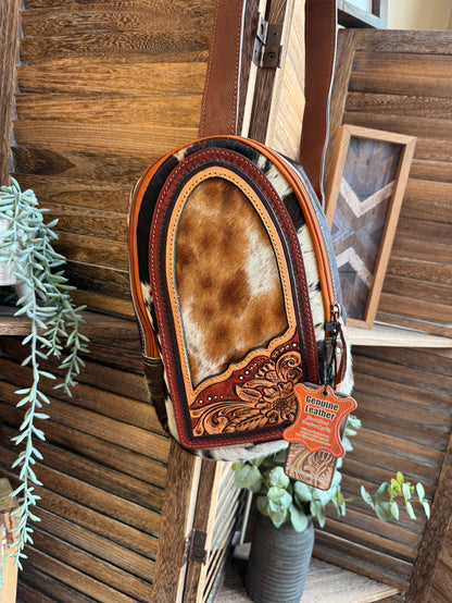 Hair-on cowhide sling/fanny bag with brown leather trim and carved floral front