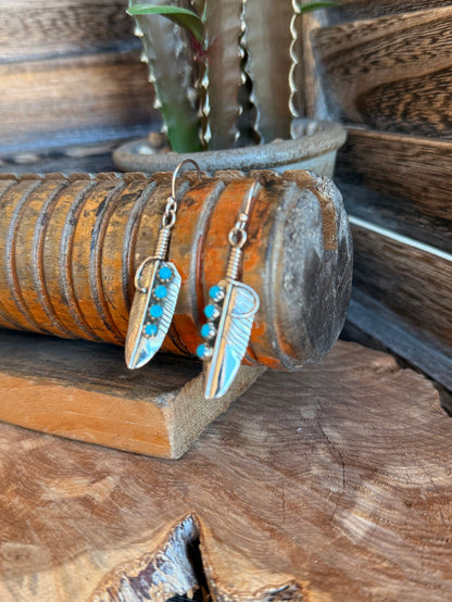 Silver drop earrings with turquoise bead row and engraved feather leaf pendants