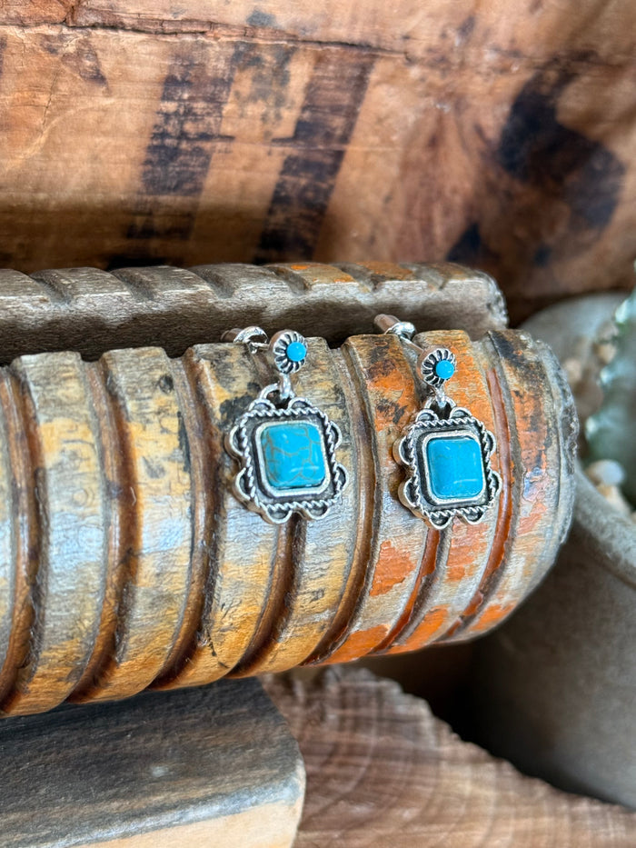 Silver and turquoise square dangle stud earrings shown from the side, with blue top bead