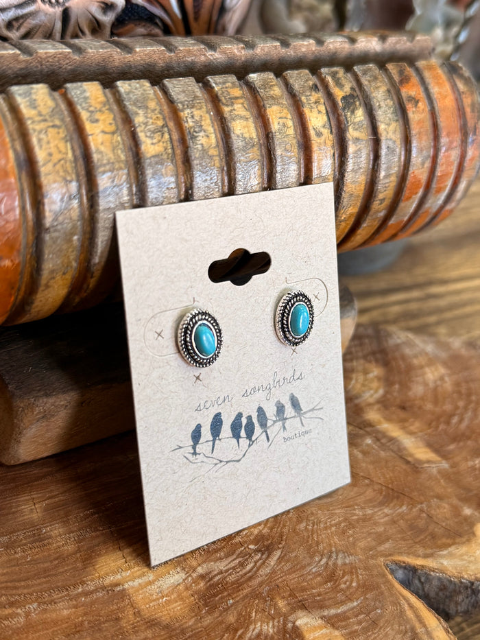 Small silver concho stud earrings with round turquoise centers and textured halo border