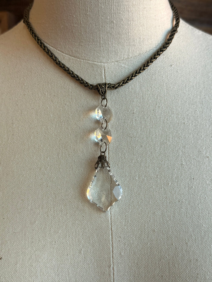 Silver-tone necklace with crystal teardrop drop pendant and small round charm accents