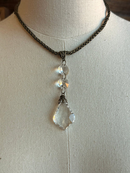 Silver-tone necklace with crystal teardrop drop pendant and small round charm accents