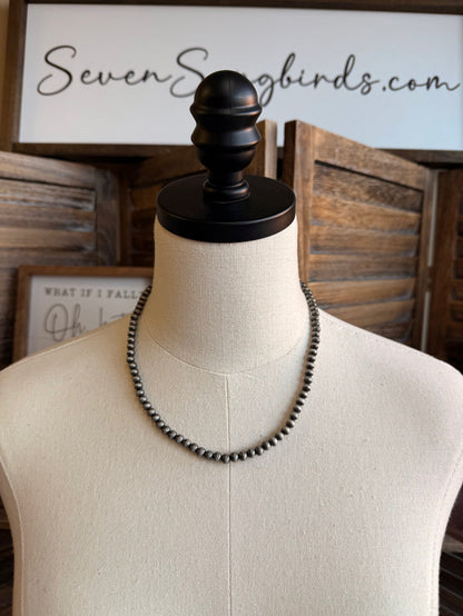 Silver pearl bead 18-inch necklace on mannequin, with dangling charm and tag