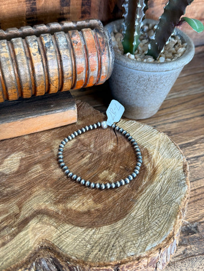 4mm sterling silver beaded stretchy bracelet with blue stamped tag