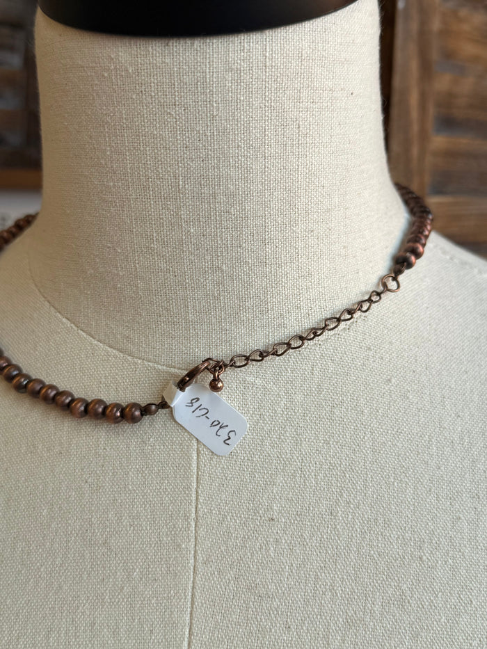 Copper-toned 6mm pearl bead necklace with small white clasp tag
