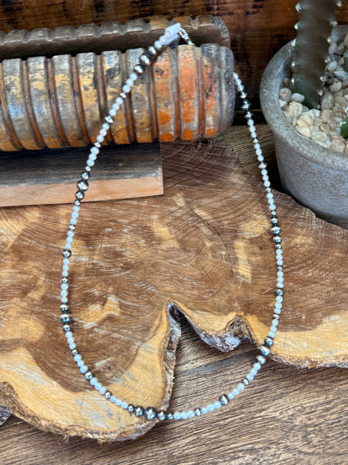 Freshwater pearl choker necklace featuring light pearls and silver bead accents