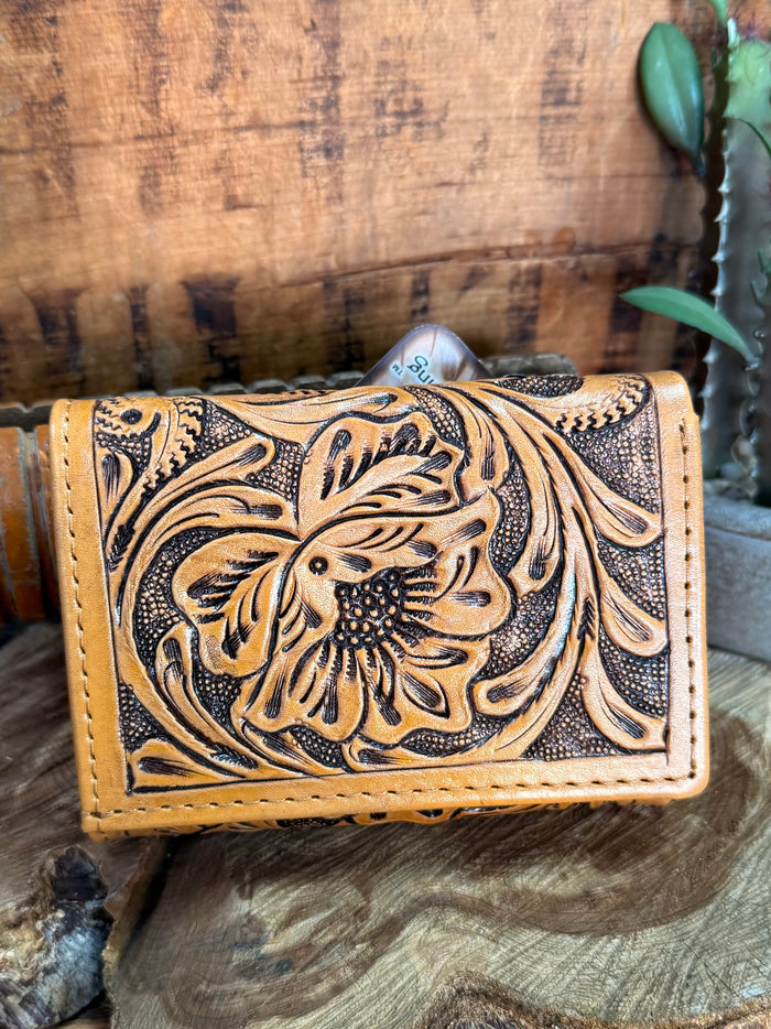 Tan leather wallet with engraved floral design and stitched edges