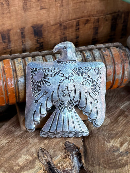 Engraved silver belt buckle with thunderbird wings and geometric floral details