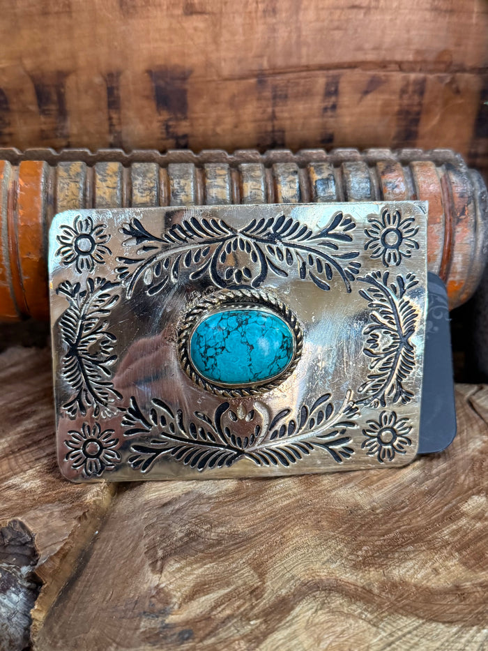 Turquoise cabochon belt buckle with detailed engraved floral border and silver finish