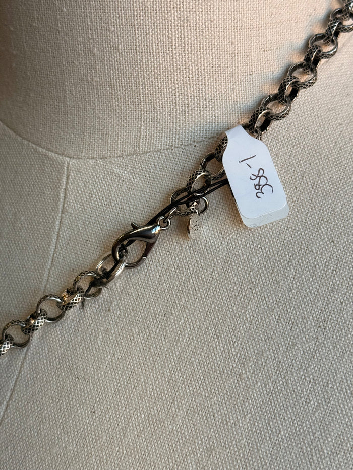Silver-tone chain necklace clasp with attached barcode-style tag