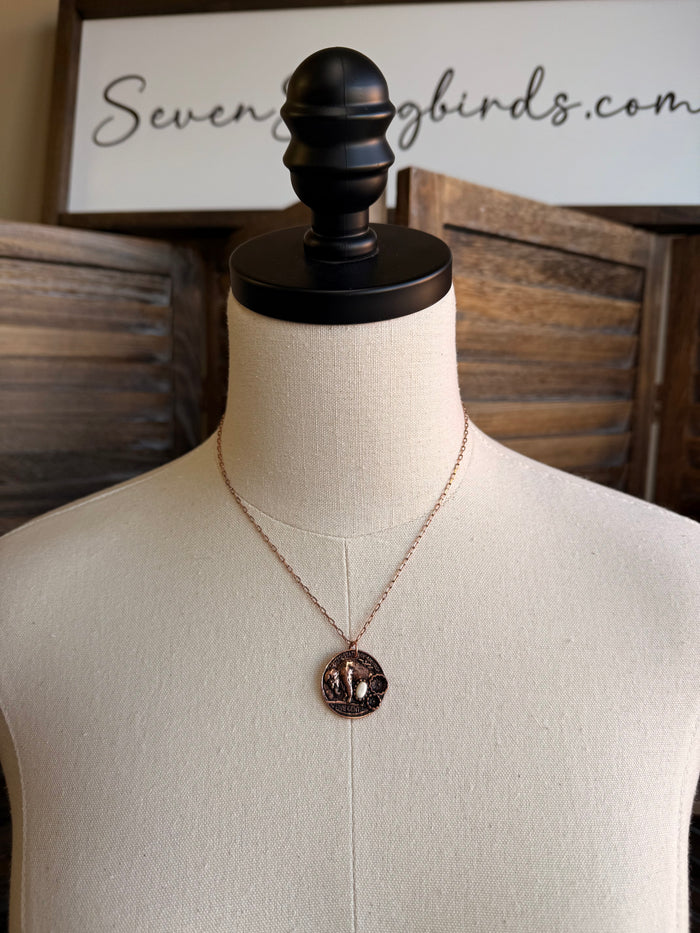 Coin necklace with round copper-toned stone pendant on thin V chain