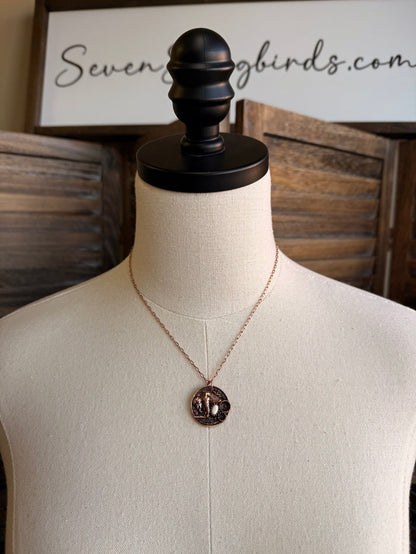Coin necklace with round copper-toned stone pendant on thin V chain