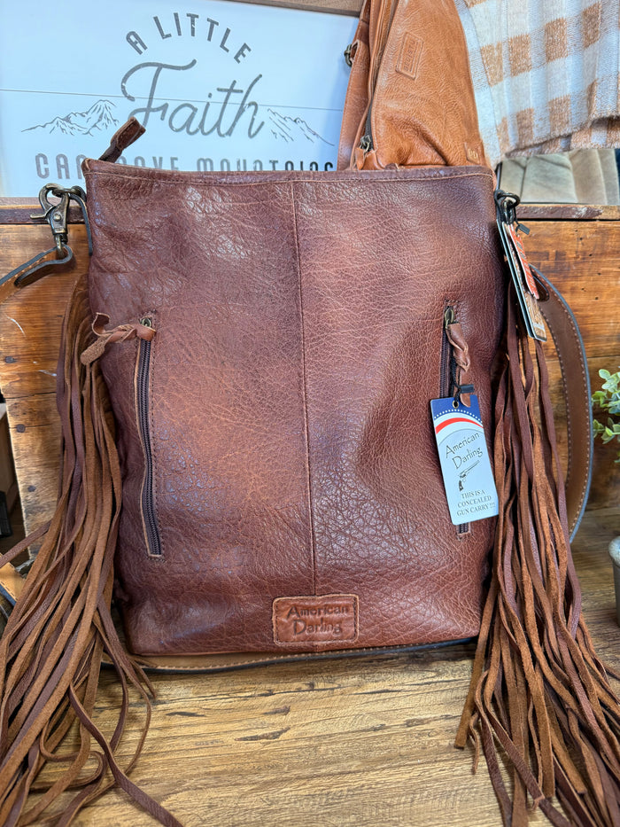 Fringed cowhide crossbody purse back view in dark brown leather with hanging tassels