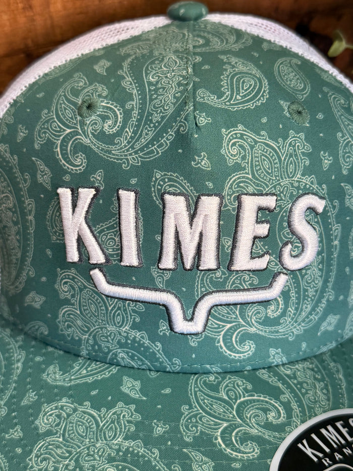 Green paisley baseball cap close-up with KIMES front letters and white stitching trim