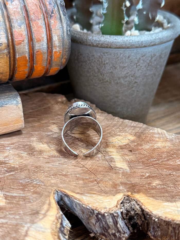 Open-back adjustable ring band with oval light-blue opal stone, silver-tone metalwork