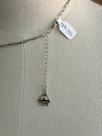 Silver drop necklace with dangling checkered bunny charm and stamped metal tag