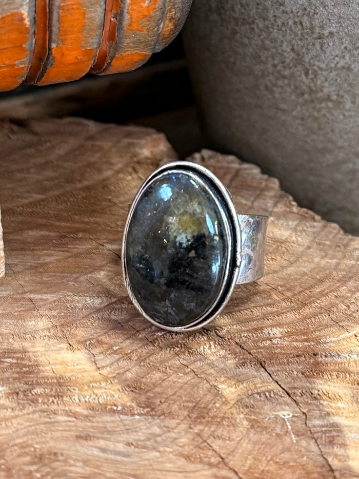 Silver-plated oval labradorite ring with glossy dark blue flash, close-up