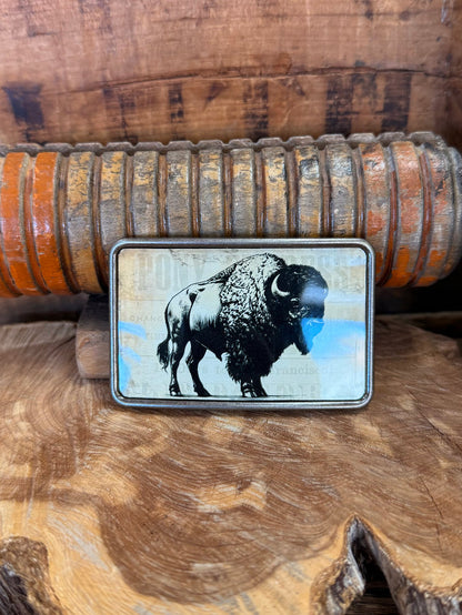 Rectangle belt buckle with buffalo graphic in clear inset and silver metal frame